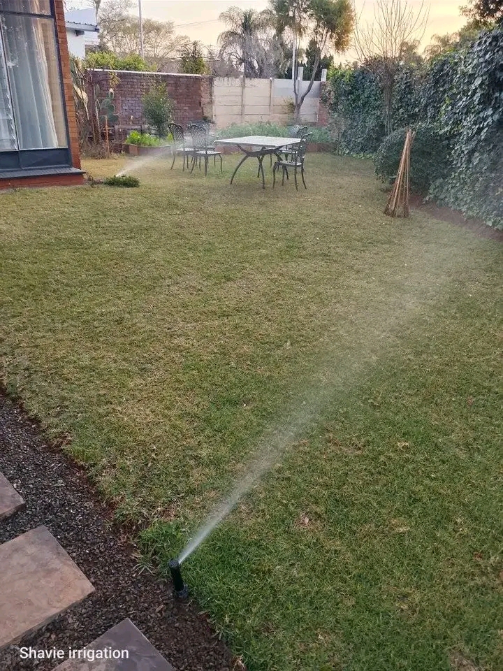Garden sprinklers watering a lawn